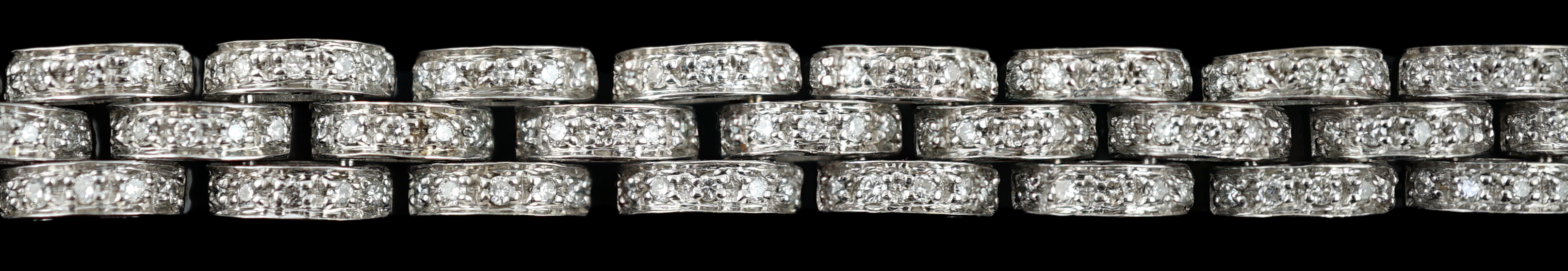 An 18k white gold and diamond chip set triple row bracelet